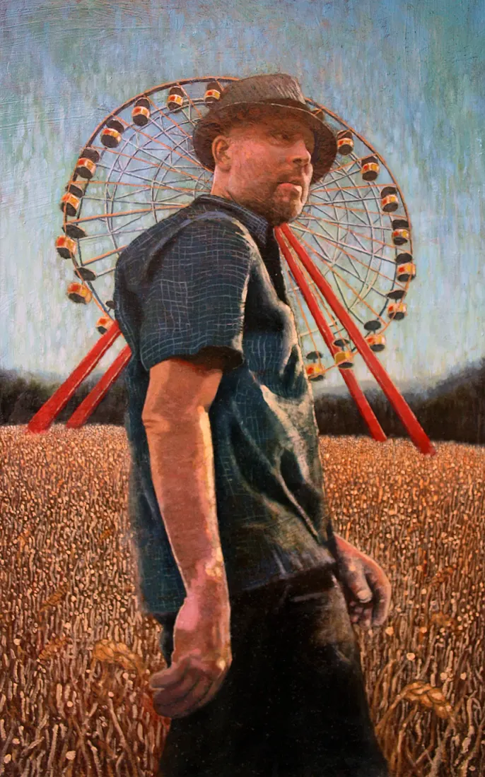 A man in a hat standing in a wheat field with a ferris wheel behind him