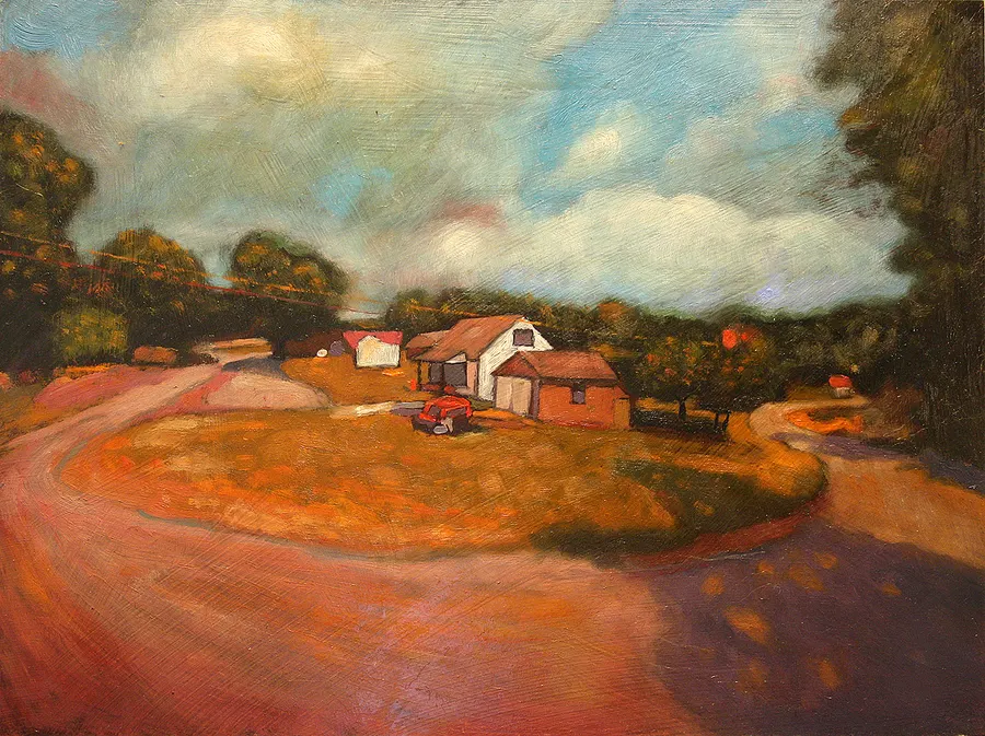 White farm buildings beside a curving orange road under a cloudy sky